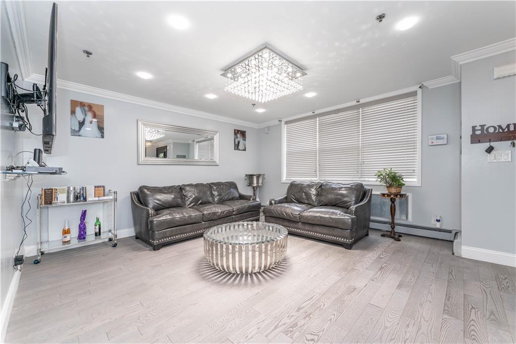 724 Egan Street Brooklyn, NY 11239 - Photo 6 of 10 a living room with furniture and a chandelier