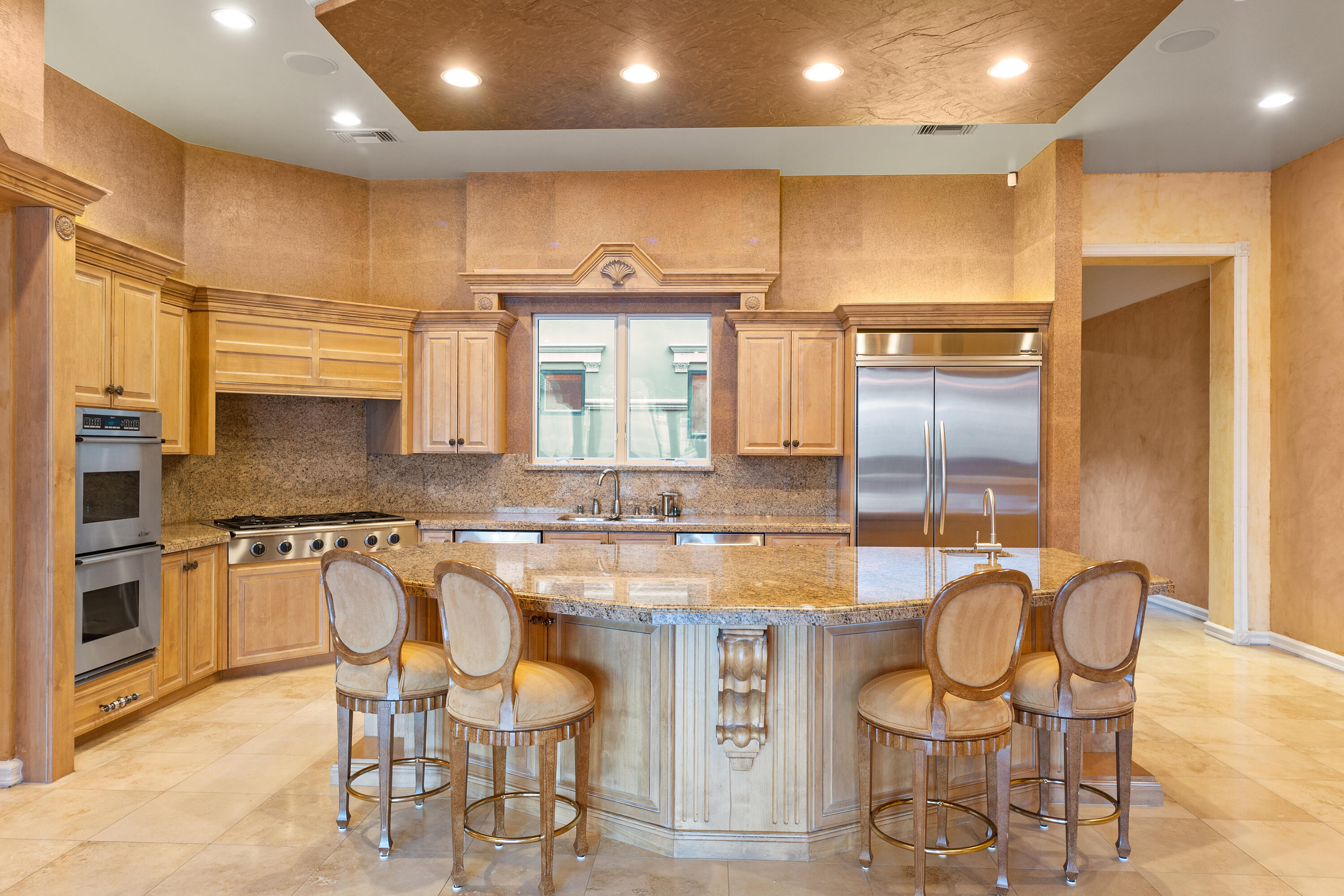 217 Via Veneto Rancho Mirage, CA 92270 - Photo 17 of 66 a kitchen with cabinets and chairs