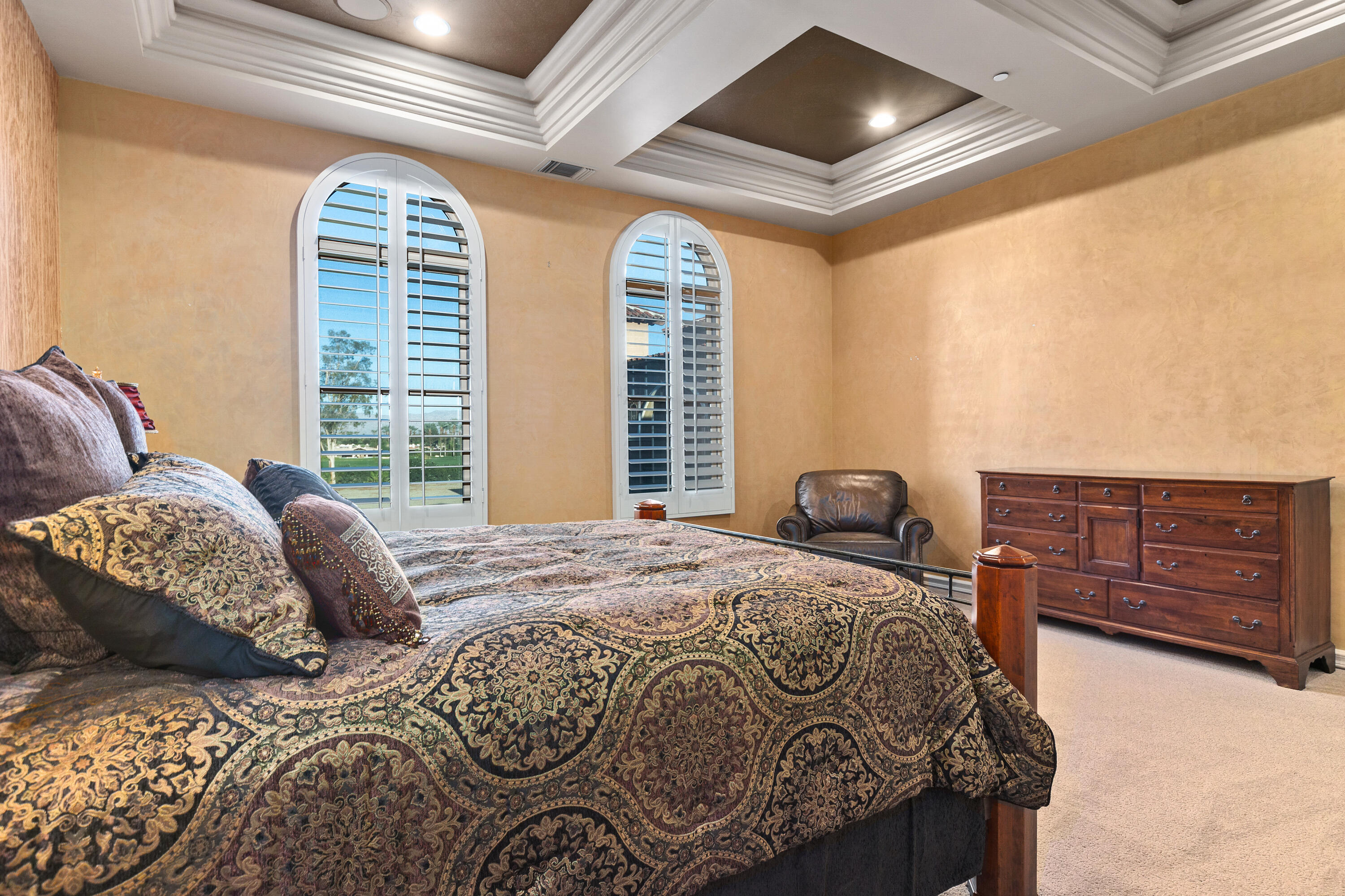 217 Via Veneto Rancho Mirage, CA 92270 - Photo 24 of 66 a bed sitting in a bedroom next to a window