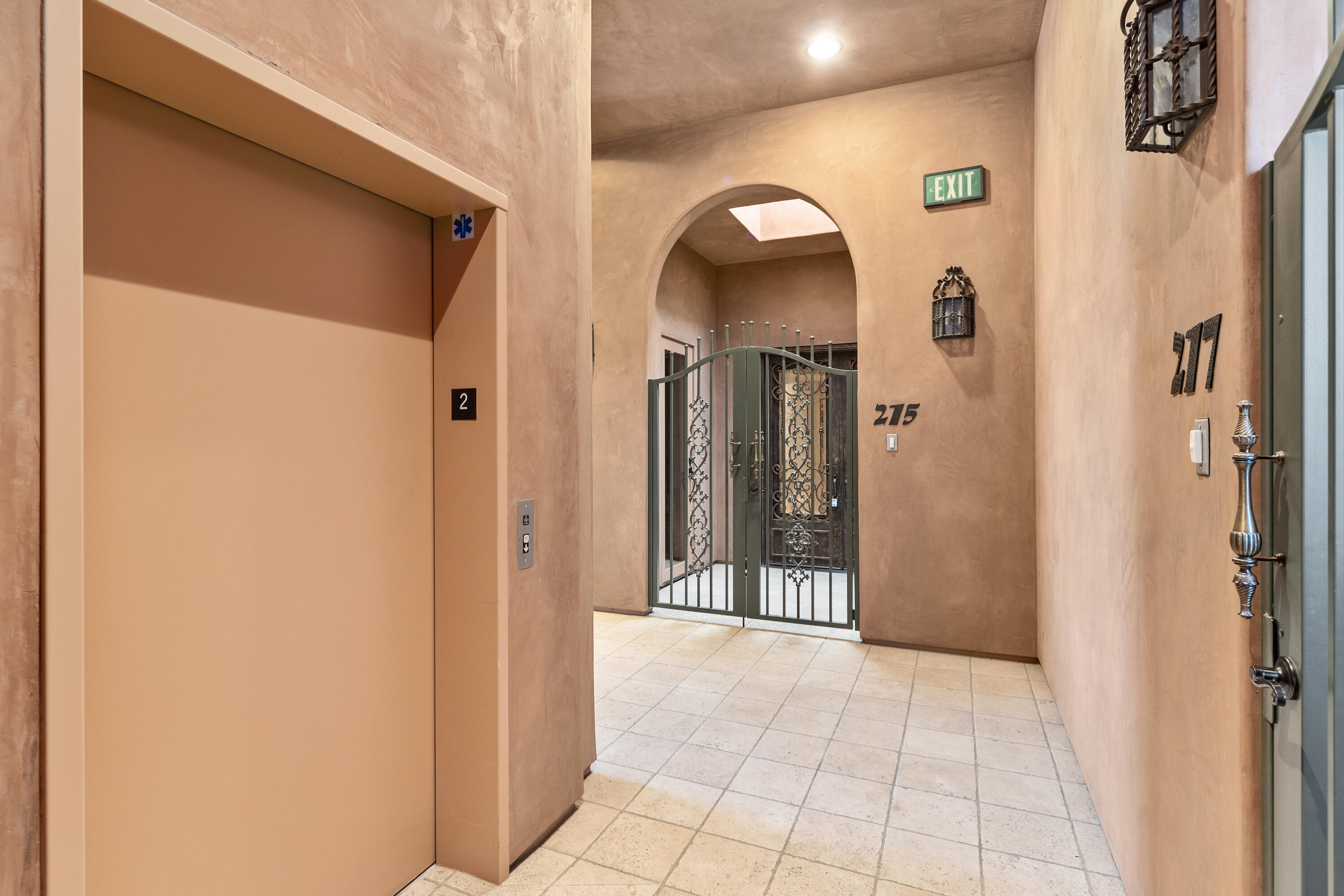 217 Via Veneto Rancho Mirage, CA 92270 - Photo 40 of 66 a view of a hallway with wooden floor and a living room