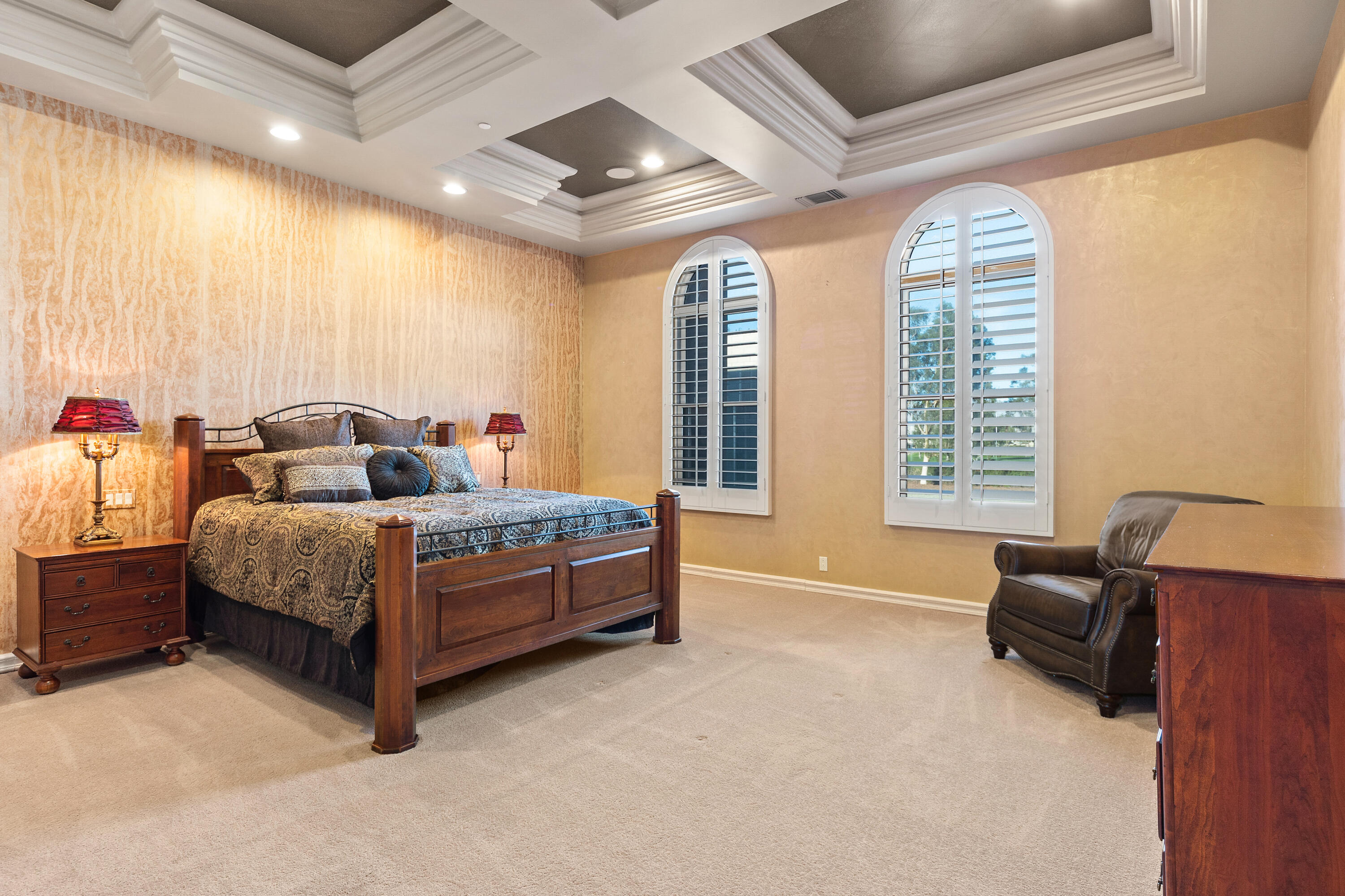 217 Via Veneto Rancho Mirage, CA 92270 - Photo 4 of 66 a bedroom with a bed couch and a large window