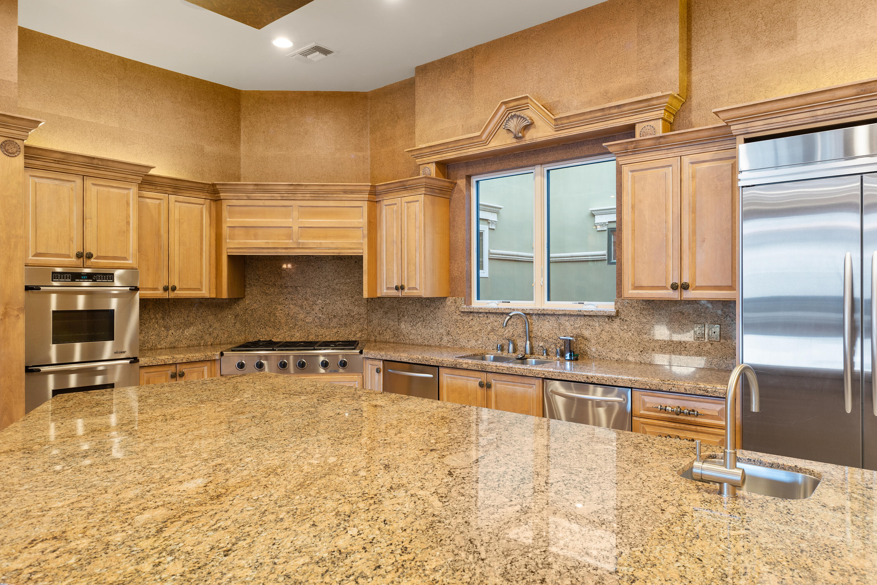 217 Via Veneto Rancho Mirage, CA 92270 - Photo 46 of 66 a kitchen with stainless steel appliances granite countertop a sink and a refrigerator