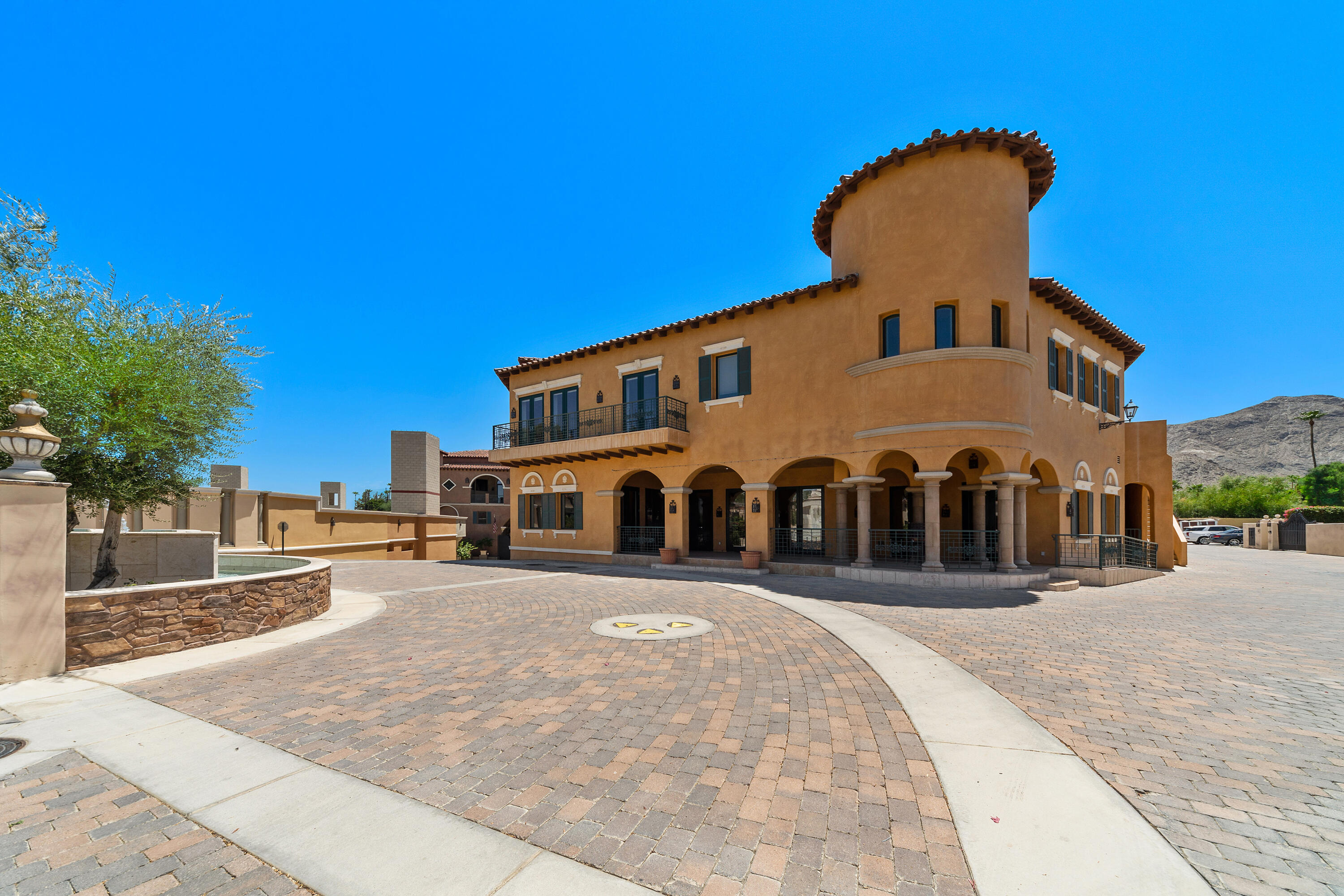 217 Via Veneto Rancho Mirage, CA 92270 - Photo 48 of 66 a front view of a house with a yard