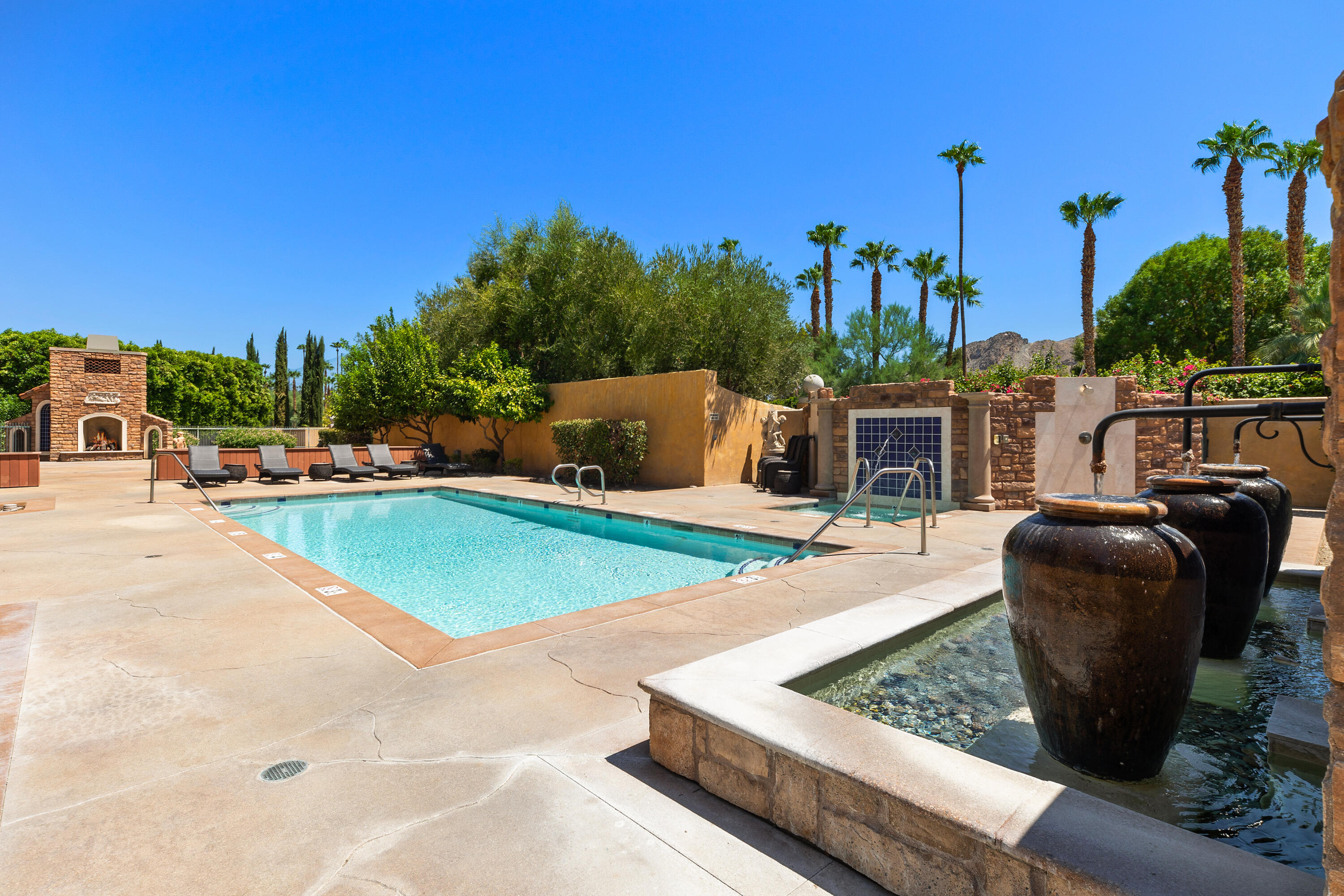 217 Via Veneto Rancho Mirage, CA 92270 - Photo 54 of 66 a view of a swimming pool with a lounge chairs