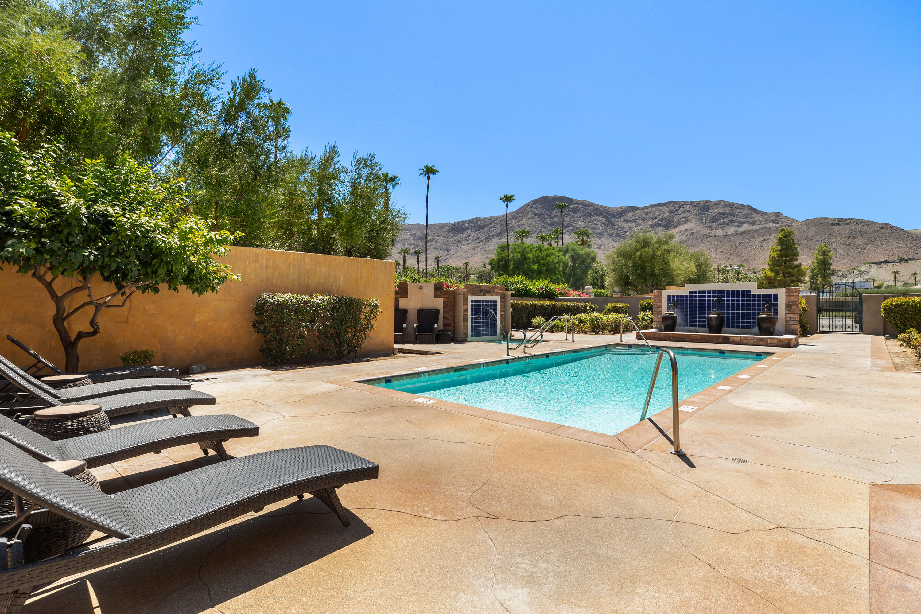 217 Via Veneto Rancho Mirage, CA 92270 - Photo 8 of 66 a view of a swimming pool with a lounge chair