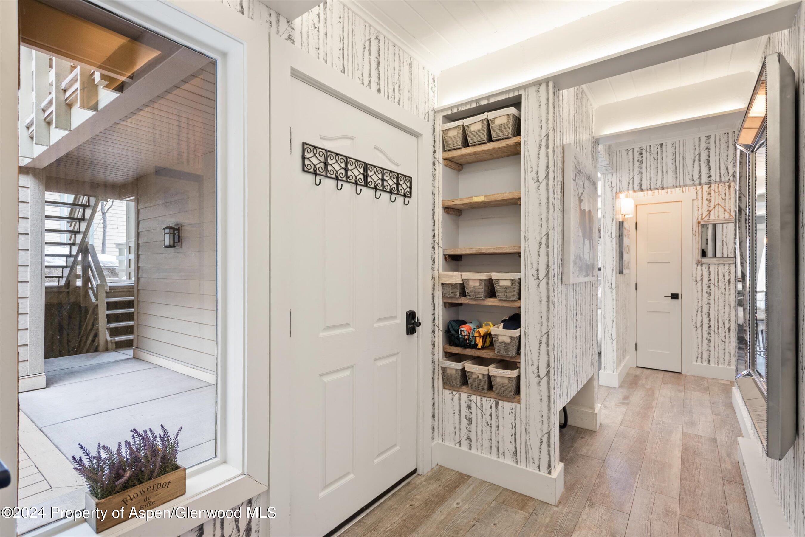825 East Hopkins Avenue, Unit 1N Aspen, CO 81611 - Photo 11 of 16 a view of a hallway with wooden floor and entryway