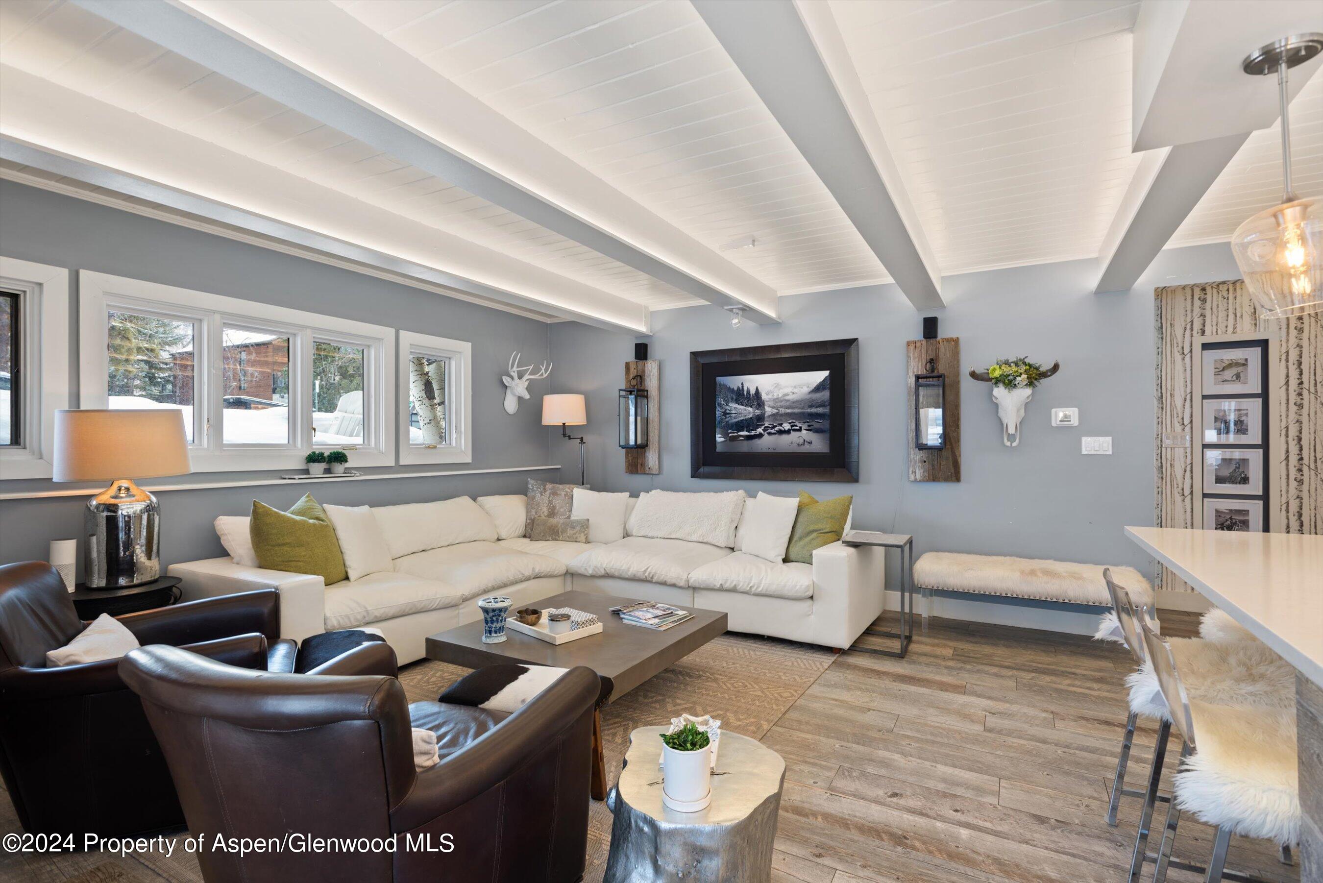 825 East Hopkins Avenue, Unit 1N Aspen, CO 81611 - Photo 2 of 16 a living room with furniture wooden floor and a large window