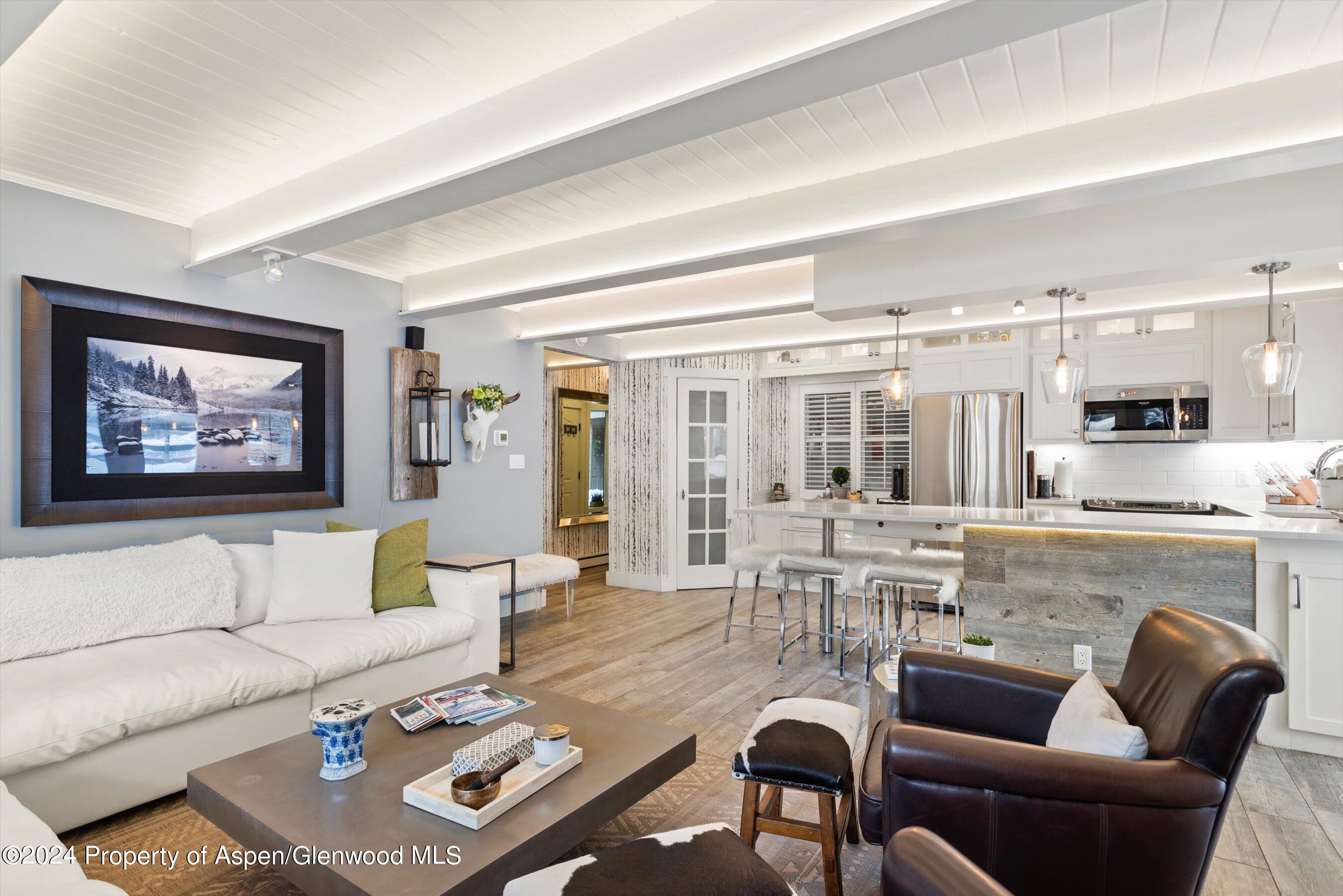 825 East Hopkins Avenue, Unit 1N Aspen, CO 81611 - Photo 3 of 16 a living room with furniture kitchen view and a large window
