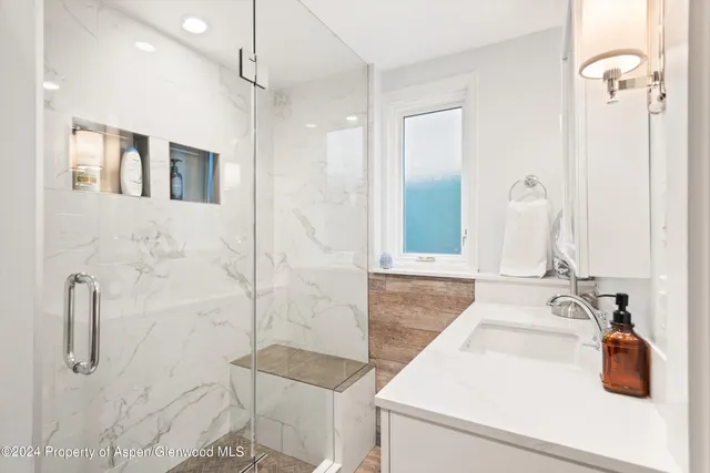 a bathroom with a sink and mirror