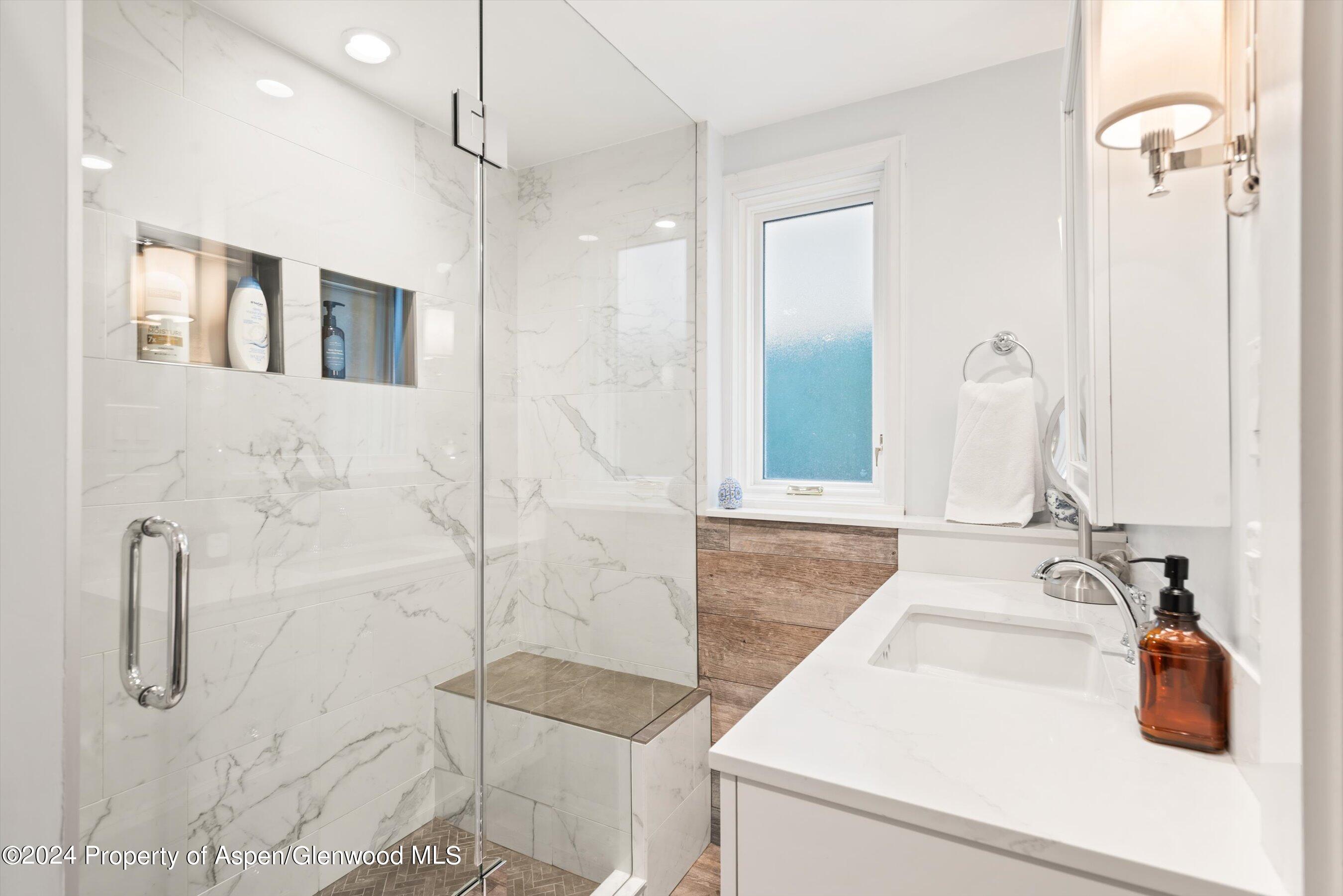 825 East Hopkins Avenue, Unit 1N Aspen, CO 81611 - Photo 8 of 16 a bathroom with a sink and mirror
