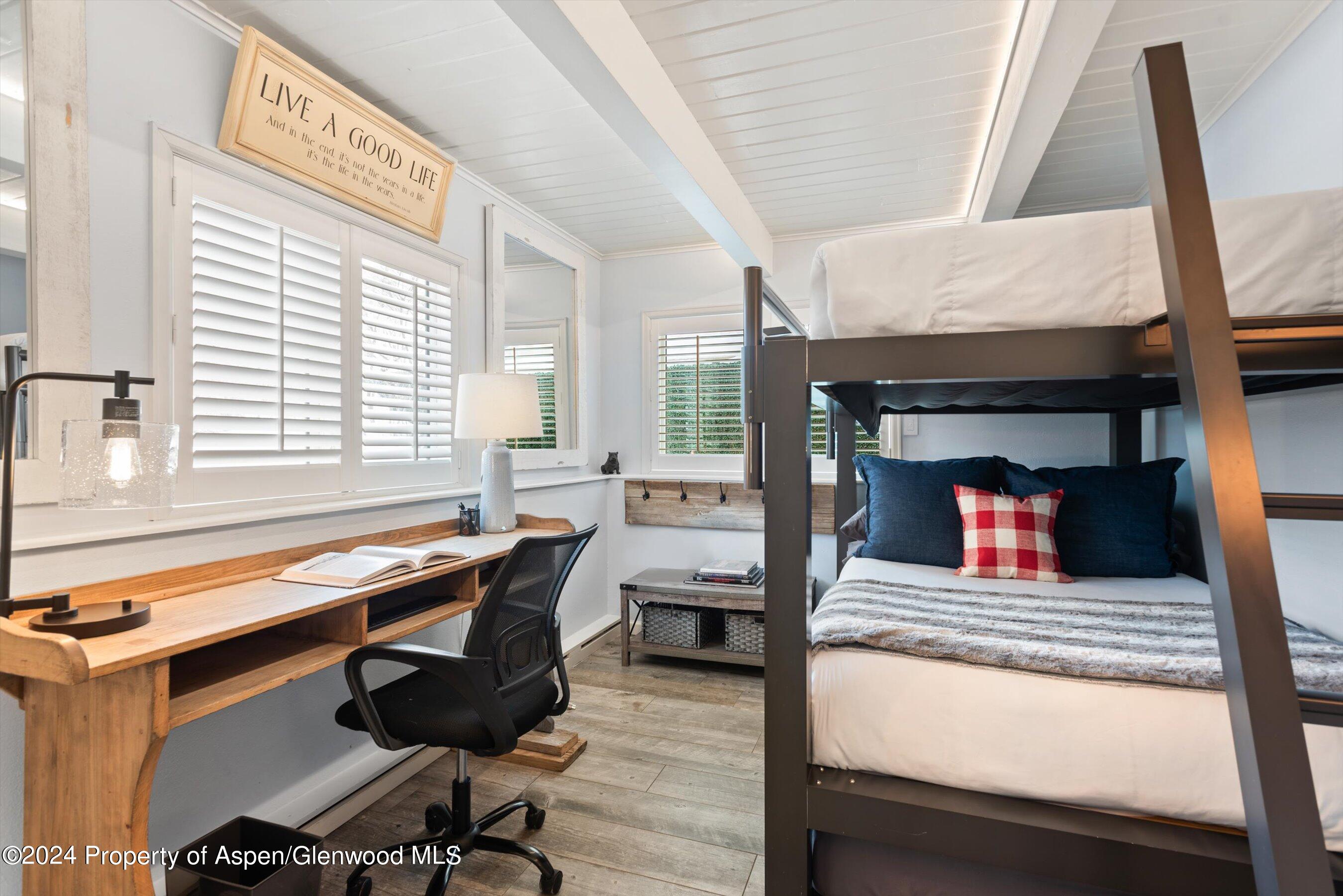 825 East Hopkins Avenue, Unit 1N Aspen, CO 81611 - Photo 10 of 16 a room with furniture and a fireplace