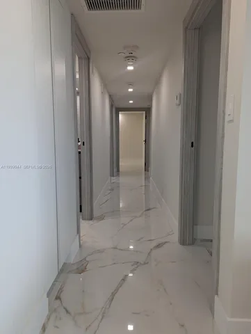 a bedroom with a bed and a night stand