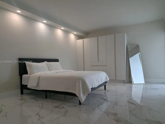 a bathroom with a shower a toilet and a sink