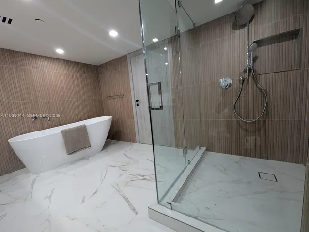 a white bath tub sitting in a bathroom