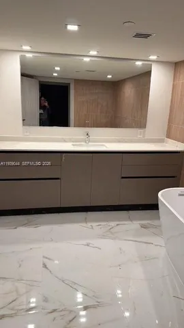a bathroom with a shower and a tub