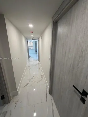 a living room with a couch and a potted plant