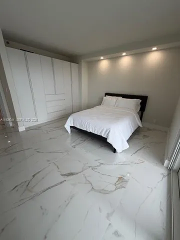 a view of a living room with a chandelier and couches