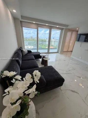 a dining room with furniture and chandelier