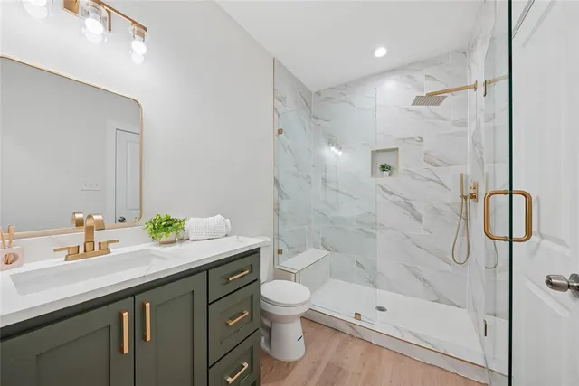 a bathroom with a toilet a sink and mirror