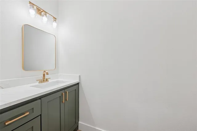 a bathroom with a granite countertop sink a toilet and shower