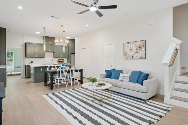 a living room with furniture and a piano