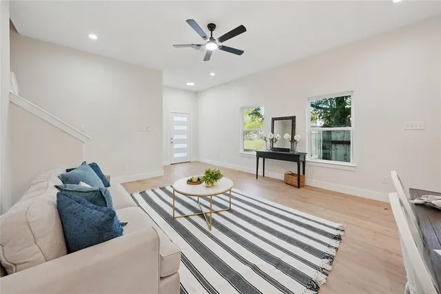 a living room with furniture and wooden floor