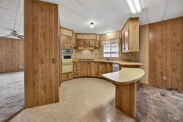 a kitchen with stainless steel appliances granite countertop a sink and cabinets