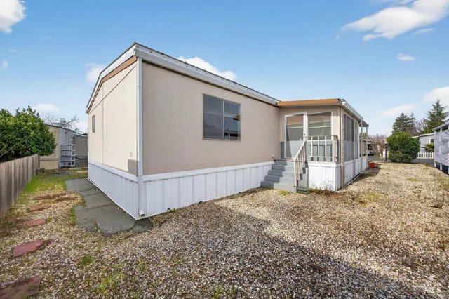 a front view of a house with basket ball court and outdoor seating