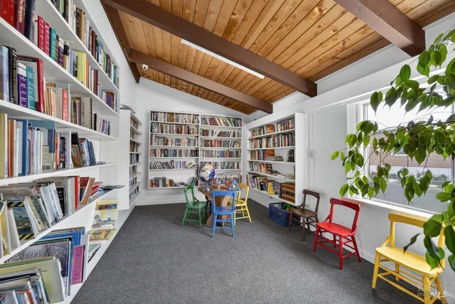 a living room with furniture and a view of kitchen