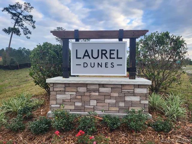 a view of sign board with yard and lake view