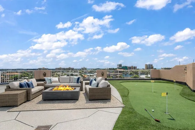 a kitchen with stainless steel appliances granite countertop a sink a stove and a wooden cabinets