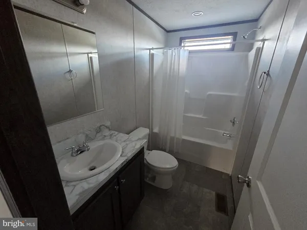 a bathroom with a sink and mirror with toilet
