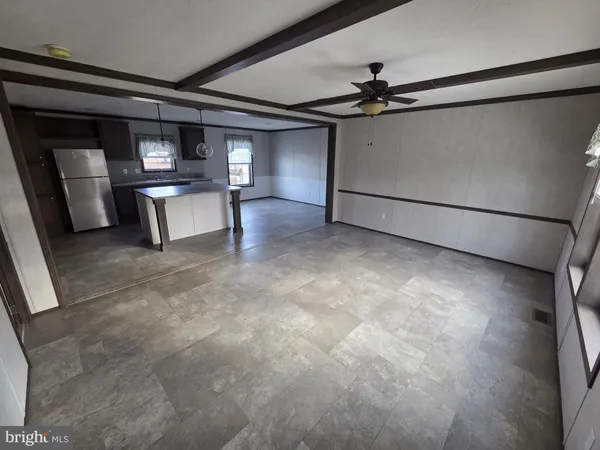a view of kitchen and refrigerator