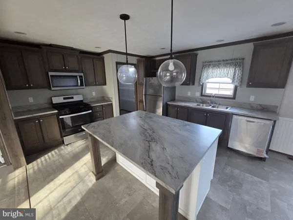 a kitchen with microwave a stove and refrigerator
