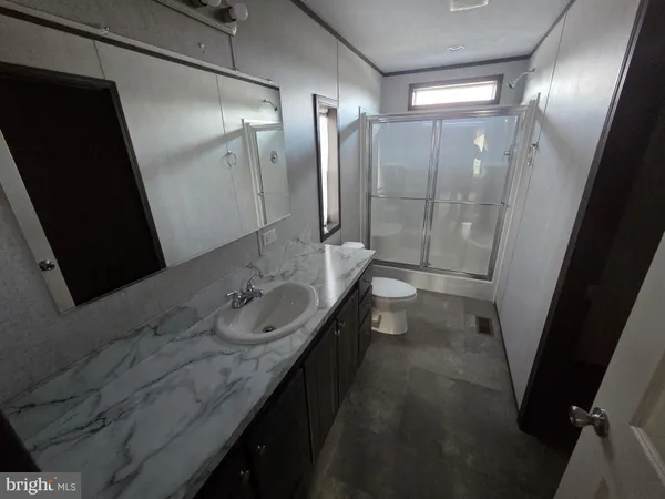 a bathroom with a double vanity sink and mirror with shower