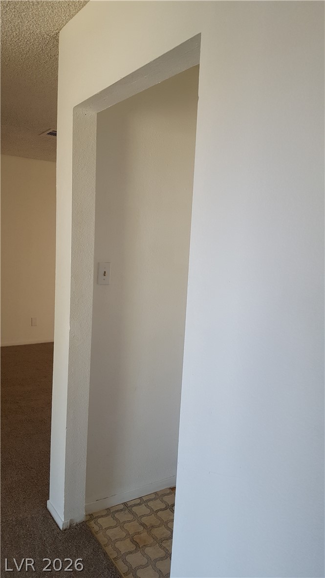 6433 Addely Drive Las Vegas, NV 89108 - Photo 21 of 27 Hall featuring carpet flooring and a textured ceiling