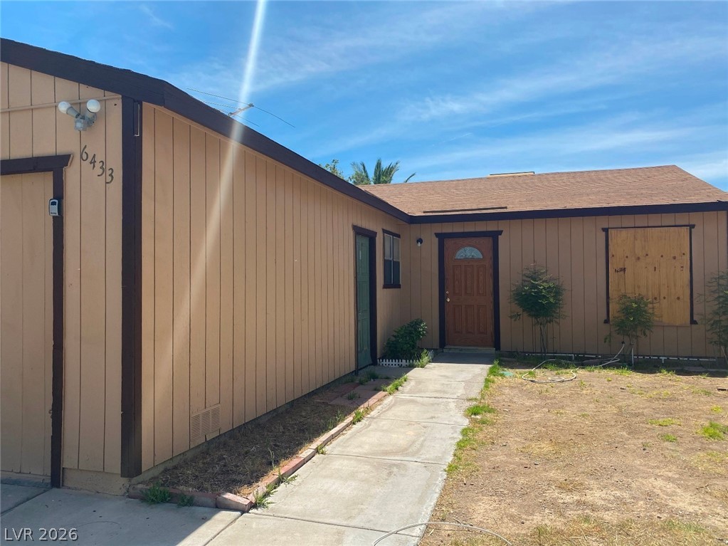 6433 Addely Drive Las Vegas, NV 89108 - Photo 3 of 27 View of exterior entry with roof with shingles