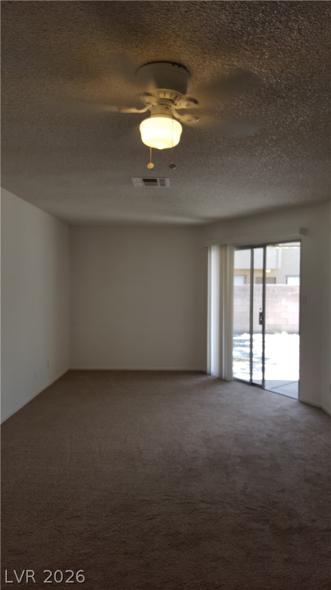 6433 Addely Drive Las Vegas, NV 89108 - Photo 10 of 27 Carpeted spare room featuring a textured ceiling and a ceiling fan