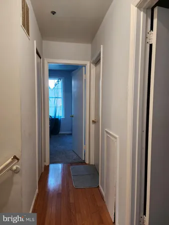a view of hallway with wooden floor