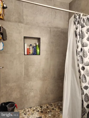 a bathroom with a shower and a sink