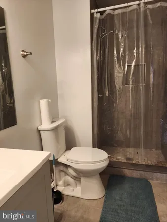 a bathroom with a toilet and a shower