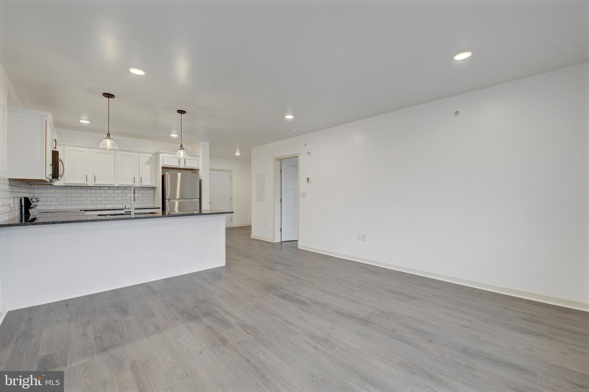 6649 Ridge Avenue, Unit C206 Philadelphia, PA 19128 - Photo 5 of 10 a view of kitchen with wooden floor and window