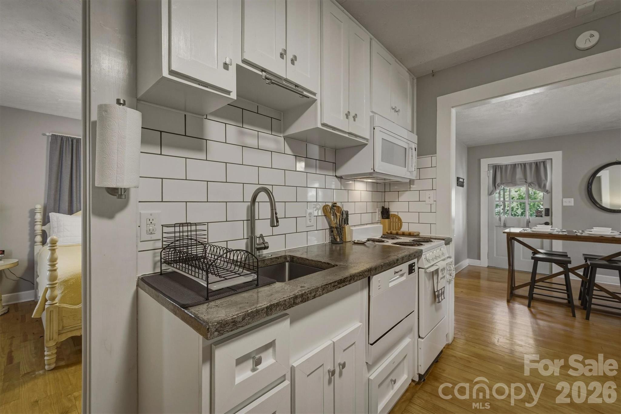 905 Carbon City Road Morganton, NC 28655 - Photo 19 of 29 a kitchen with stainless steel appliances granite countertop a sink stove and cabinets