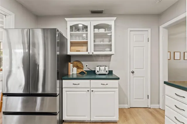 a kitchen with stainless steel appliances a refrigerator and cabinets