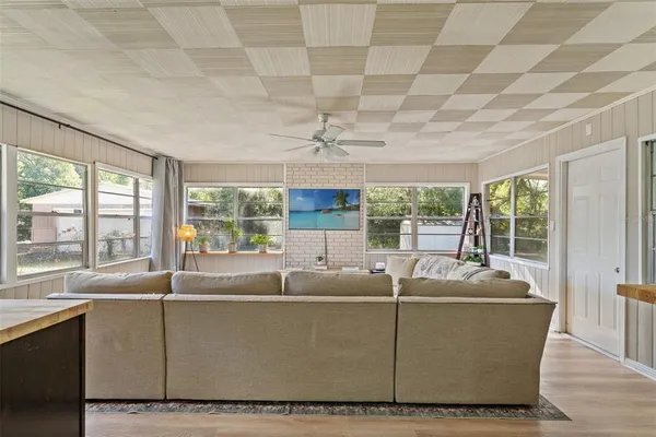 a living room with furniture and a floor to ceiling window