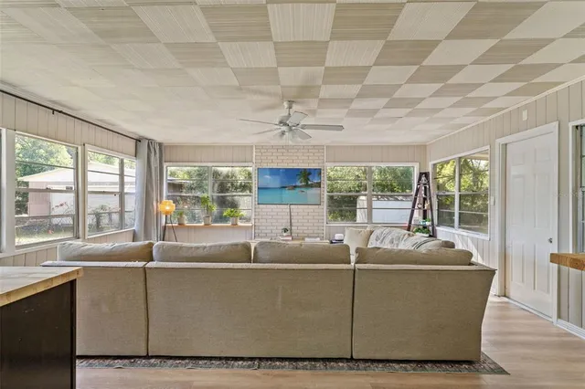a living room with furniture and a floor to ceiling window