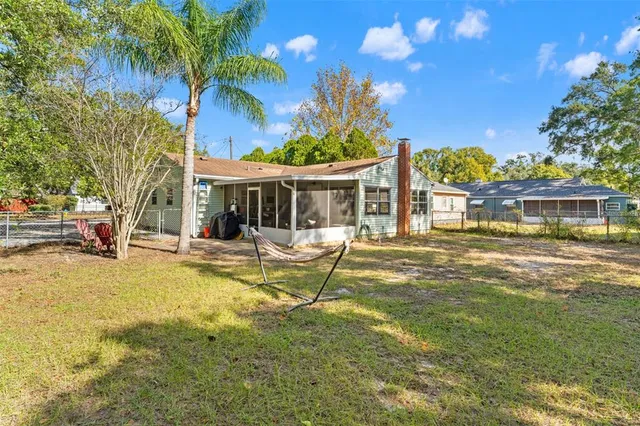 a view of a house with swimming pool and sitting area