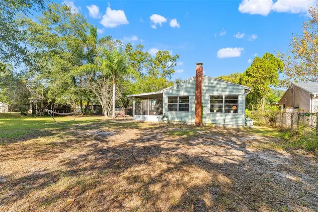 a view of a house with a backyard