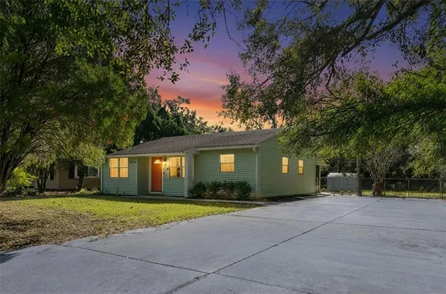 a front view of house with yard and green space