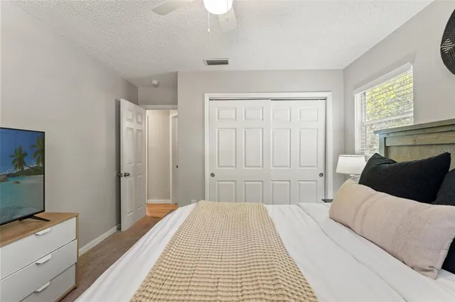 a bedroom with a large bed and a dresser